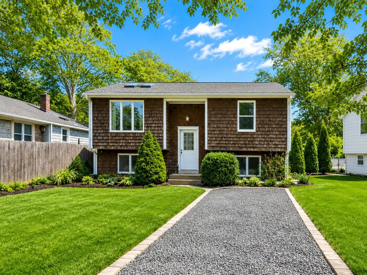 The Anchorage — cedar-shingle home with stone walkway and tree-lined yard